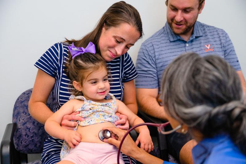 a girl getting a medical exam with her family